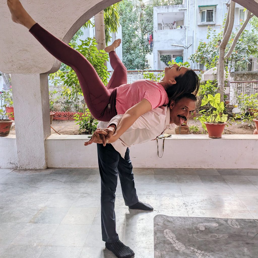 Photo de deux personnes en train de pratiquer le Yoga.